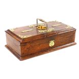 A Victorian oak and brass bound cigars and cigarettes box, the brass handled top above a circular br