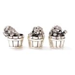 Three Saturno silver figures modelled as puppies in barrels, each marked 925, 2cm high.