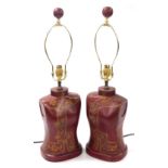A pair of Chinese faux red lacquer table lamps, of female bust form, gilt decorated with flowers, 40