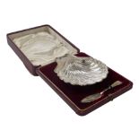 An Edward VII silver and cut glass butter dish, of scallop shell form, with butter knife, cased, Lev