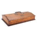 An early 20thC oak butler's cutlery box, with a copper carrying handle, having four compartments nam