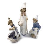 Three Lladro porcelain figures, comprising a girl kneeling with a lamb, standing girl with basket, a