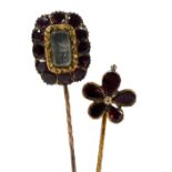 A Victorian garnet and hair locket tie pin, in yellow metal, and a further garnet set tie pin, form