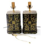 A pair of Chinese black lacquer table lamps, of canted rectangular form, painted with flowers and sc