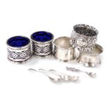 A pair of 20thC Indian Colonial silver open salts, with pierced decoration and blue glass liners, Ha