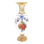 A late 19thC French milk glass vase, of baluster form, painted with sprays and scrolls of flowers, b