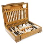 A Christofle silver plated canteen of cutlery, monogram engraved, twelve place settings, oak cased,