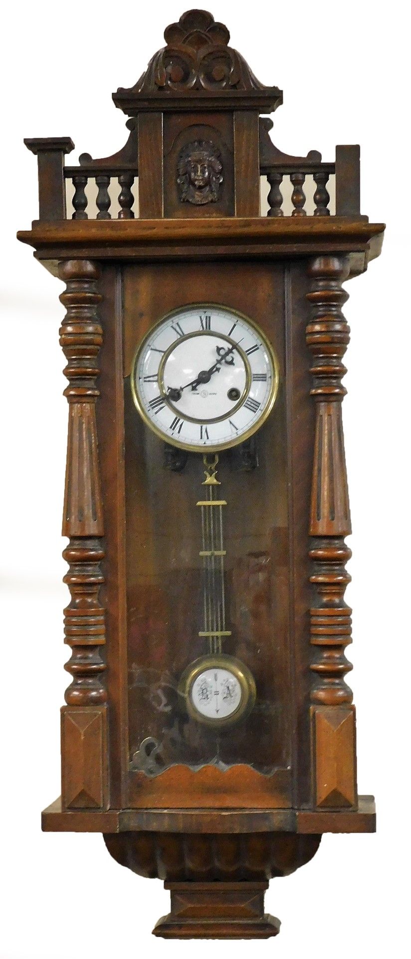 A late 19thC oak cased Vienna wall clock, circular brass dial with enamel chapter ring bearing Roman