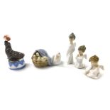 Three Lladro porcelain cherub Christmas ornaments, a Lladro porcelain figure of a seal with a ball,