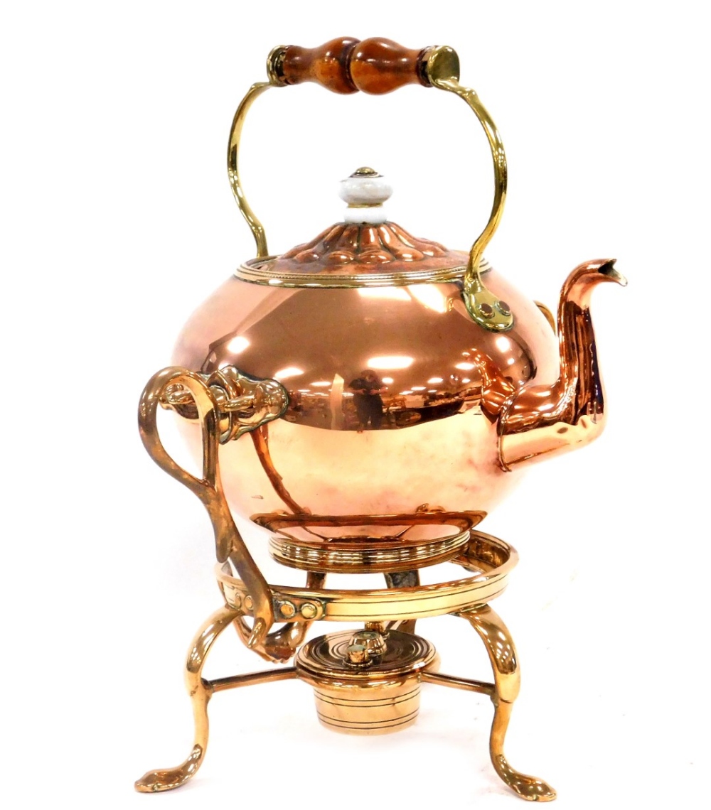 A Victorian copper and brass tea kettle, on stand, with burner, 37cm high.