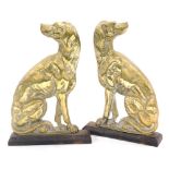 A pair of Victorian brass and iron door stops, modelled as seated greyhounds, 33cm high.