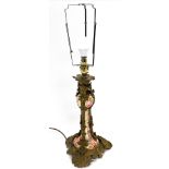 A late 19thC pottery and brass overlaid candlestick, converted to a table lamp, painted with flowers