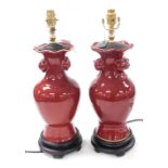 A pair of Chinese sang-de-boeuf vase form table lamps, of baluster form, with fruit moulded handles,