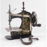 An early 20thC Muller child's toy sewing machine, model number 4, boxed with instructions.