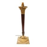 A brass and mahogany Corinthian column table lamp, with a fluted column raised on a square base, 58c