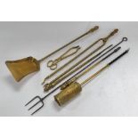 A group of Victorian and later fire irons, comprising a matching shovel, poker, and coal tongs, toge