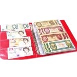 An album containing GB and world bank notes, to include Elizabeth II bank notes, £20, £10, and £5, b