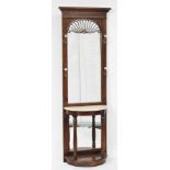 A Victorian style mahogany hall stand, the dentil moulding pediment over an arched glass plate, with