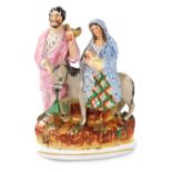 A 19thC Staffordshire flatback figure group, modelled as Joseph, Mary on a donkey with the baby Jesu