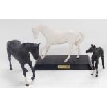 A Beswick matt white figure of Spirit Of Youth, raised on a wooden base, together with a matt black