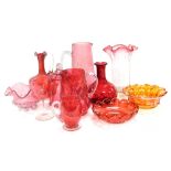 A group of Victorian and later cranberry glassware, including a claret jug, vase, wine glass, jar an