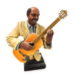 A plaster sculptural bust of a guitar player, raised on an ebonised base, 42cm high.