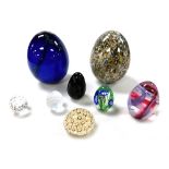 A group of glass and crystal paperweights, including a large Murano blue glass egg formed paperweigh