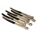 A set of six George III King's pattern silver handled table knives, crest engraved, with later stain