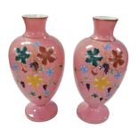 A pair of late 19thC pink opaline glass vases, of baluster form, painted with vines, and applied wit