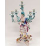 A 19thC Meissen five branch figural and flower encrusted candelabrum, modelled with a seated lady on