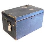 A Victorian black leather bound travel trunk, with a pair of cast iron carrying handles, bearing lab