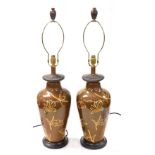 A pair of Chinese brown glazed table lamps, of shouldered tapering form, decorated with flowers and