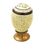 A late 18thC Bilston enamel nutmeg grater, modelled as an egg, the hinged lid decorated with 'As The