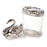 A 20thC cut glass and silver open salt modelled as a swan, with pierced and floral embossed opening