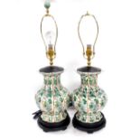 A pair of Chinese porcelain famille verte table lamps, of fluted baluster form, decorated with panel