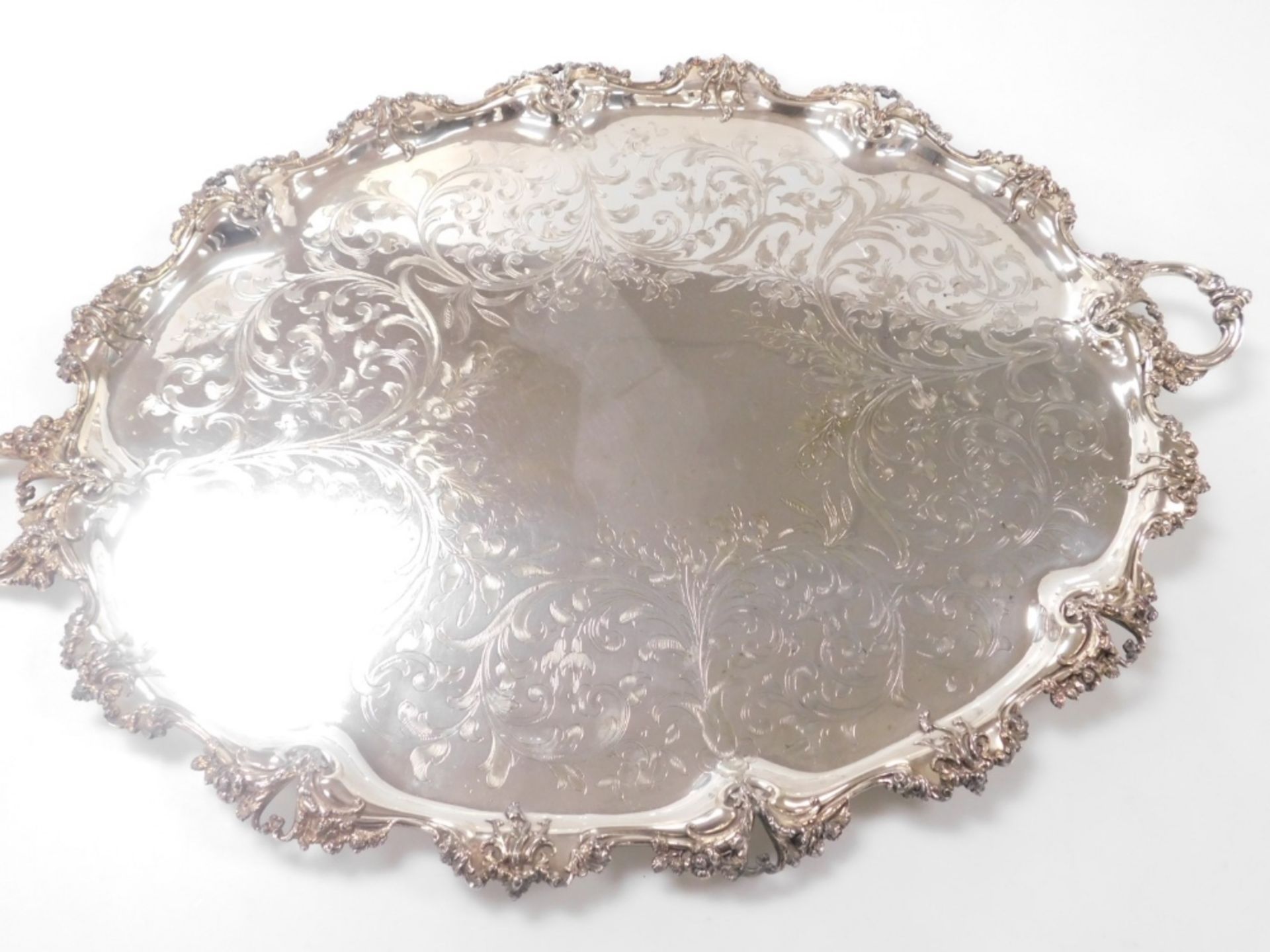 A Victorian silver plated twin handled tray, with central floral and foliate engraving, within a rai - Image 2 of 3