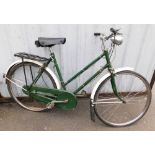 A mid century Raleigh bicycle, in green trim.