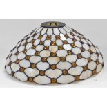 A Tiffany style light shade, of tapering form, decorated with amber roundels against a cream ground,