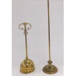 A Victorian brass demi lune doorstop, with scroll handle, 45cm high, together with a brass stand, or