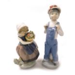 A Lladro porcelain figure modelled as a boy standing in dungarees, with a squeeze box, and a girl wi