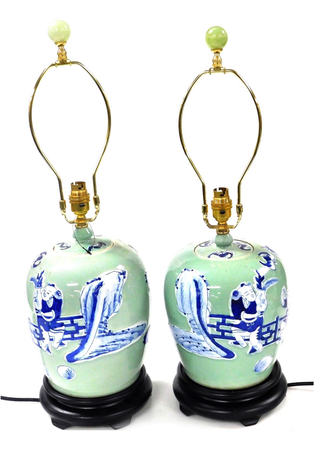 A pair of Chinese blue and white jar and cover table lamps, decorated with figures against a celadon