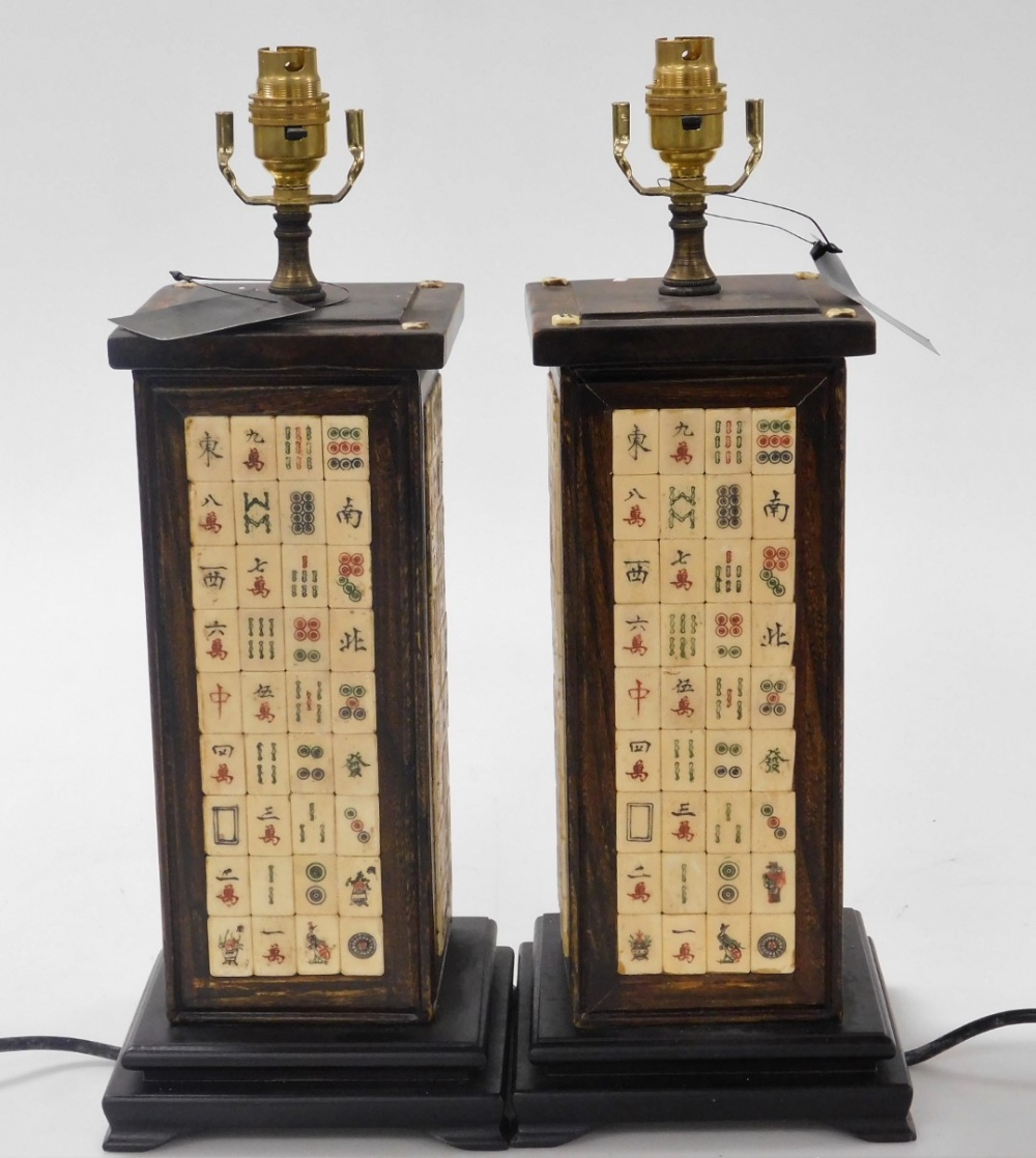 A pair of Chinese hardwood table lamps, of rectangular section, inlaid with panels of mahjong counte