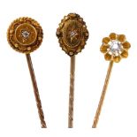 Three Victorian tie pins, each centrally set with an old cut or rose cut diamond in yellow metal, 5.