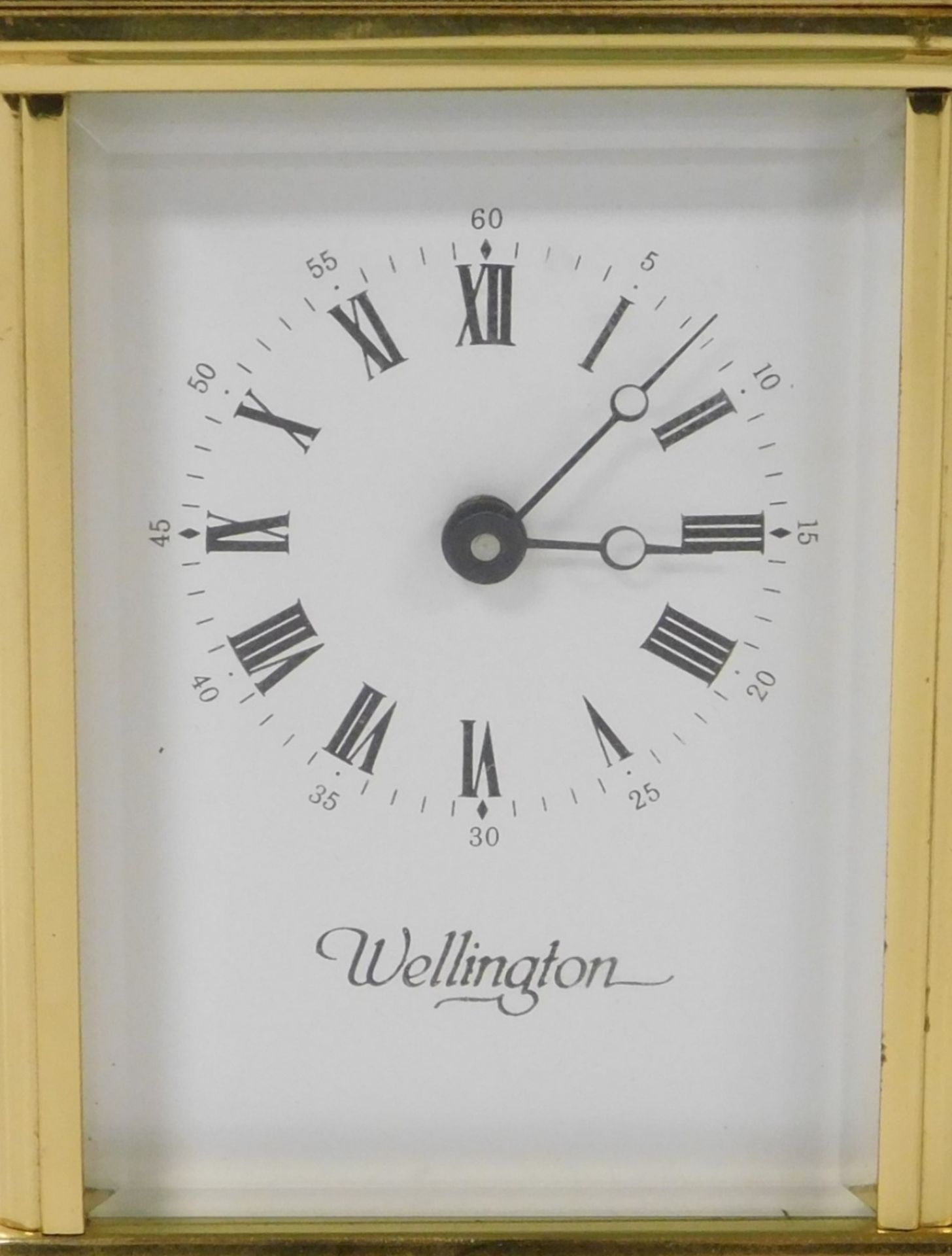 A 20thC brass cased carriage clock, the white enamel dial bearing Roman numerals for Wellington, key - Image 2 of 4