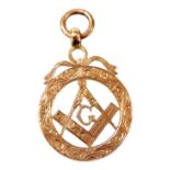 A 9ct rose gold Masonic pendant, engraved and pierced with a set square and compass, and a letter G,