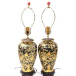 A pair of Chinese ceramic table lamps, of shouldered baluster form, gilt decorated with scrolling le