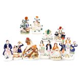 A group of 19thC Staffordshire figures, including a seated figure of a snuff taker, and a dancing fi