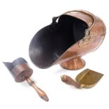 A Victorian copper helmet shaped coal scuttle, with two coal shovels, 39cm wide.