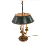 An early 20thC Continental brass three branch table lamp, with a green painted tin shade, raised on
