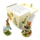 A Royal Albert pottery figure modelled as Peter Rabbit, another of Foxy Reading, both boxed, and a p